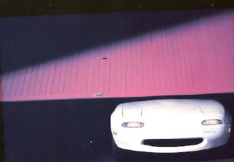 car peeking out of garage