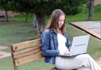 Woman in park working on computer