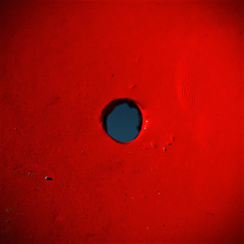 single black dot on red field