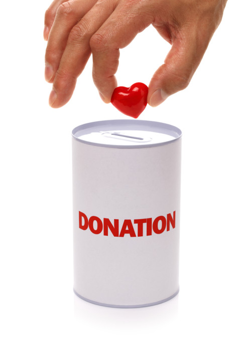 dropping a heart into donation can