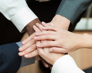 Close-up of people with hands together. Concept of union in busi