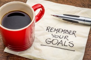 remember your goals - handwriting on a napkin with a cup of epsr
