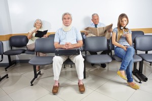 Different people sitting in a waiting room of a hospital