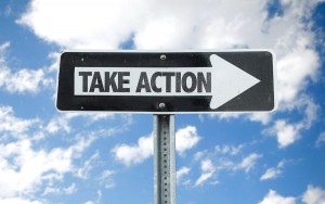 Take Action direction sign with sky background