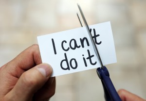 Man using scissors to remove the word can't to read I can do it