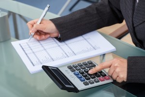 Businesswoman Calculating Tax