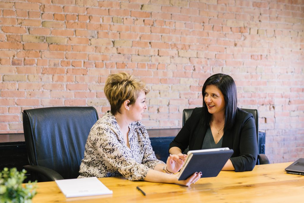 two women seated at laptop